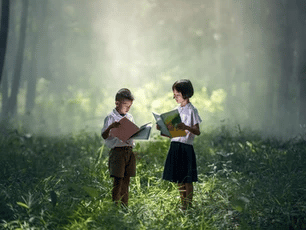 Two kids in the woods reading books