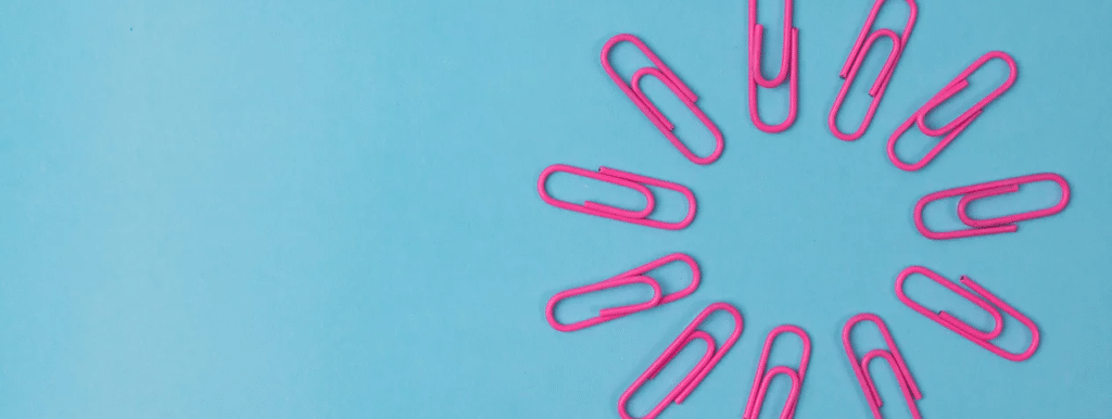 pink paper clips on a blue background
