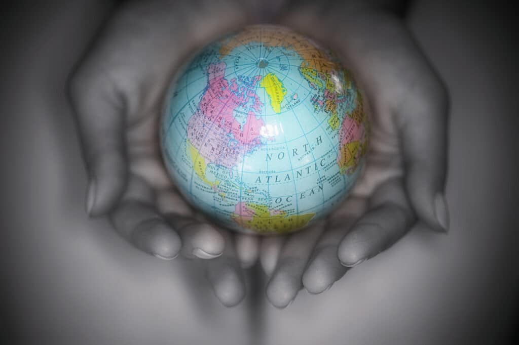 Hands Holding a Small Globe Image by Laura Zera © Royalty-Free/Corbis