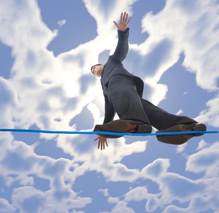Lean young businessman walking on line in the air. Holding balance. Low angle view.