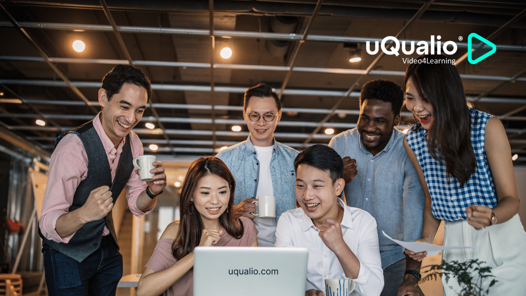 Customer Education employees with laptop uQualio
